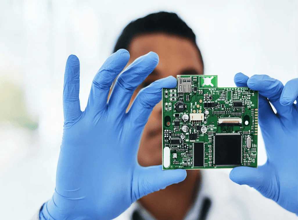 Engineer holding motherboard for electronics design - Infinecs